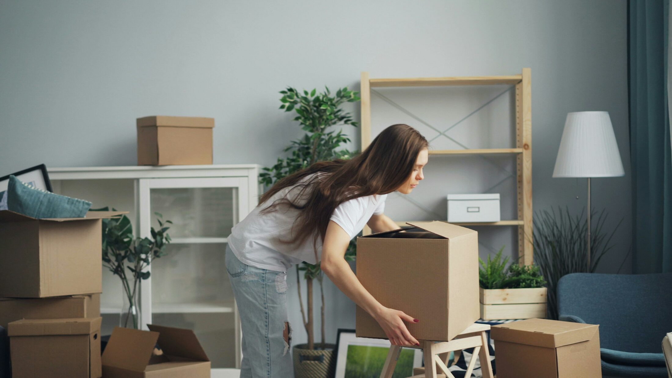 Person relocating into an apartment with moving boxes